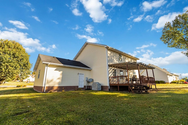 rear view of house with a deck, a lawn, and a pergola