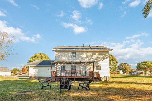 back of house with a deck and a lawn