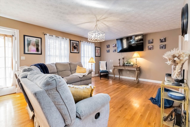 living room featuring a textured ceiling, hardwood / wood-style flooring, and a wealth of natural light