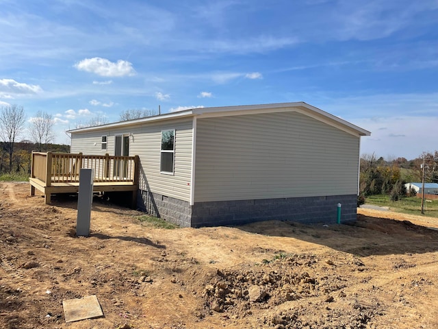 view of side of home with a wooden deck