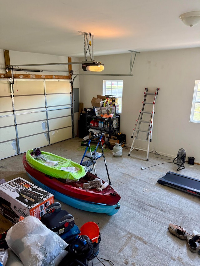 garage with a garage door opener and electric panel