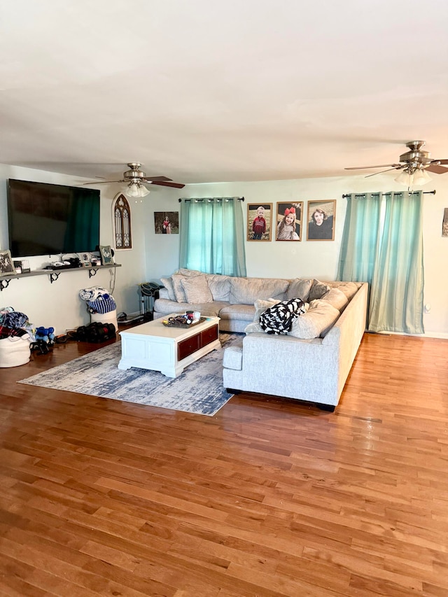 living room with hardwood / wood-style flooring and ceiling fan