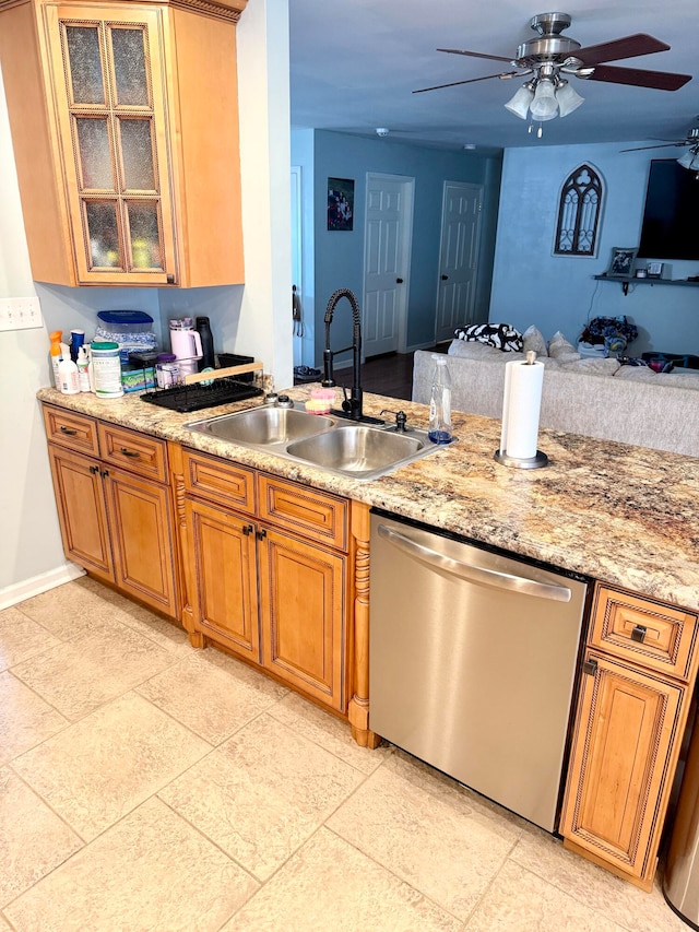 kitchen with sink, dishwasher, light stone countertops, and ceiling fan