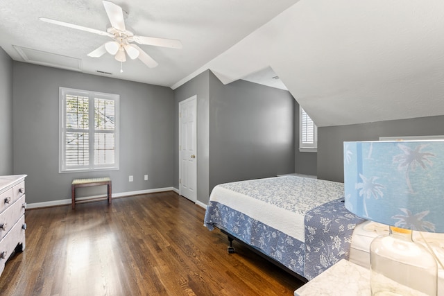 bedroom featuring dark hardwood / wood-style flooring, a textured ceiling, vaulted ceiling, and ceiling fan