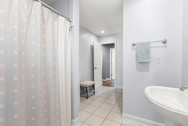 bathroom featuring a shower with curtain, sink, and tile patterned floors