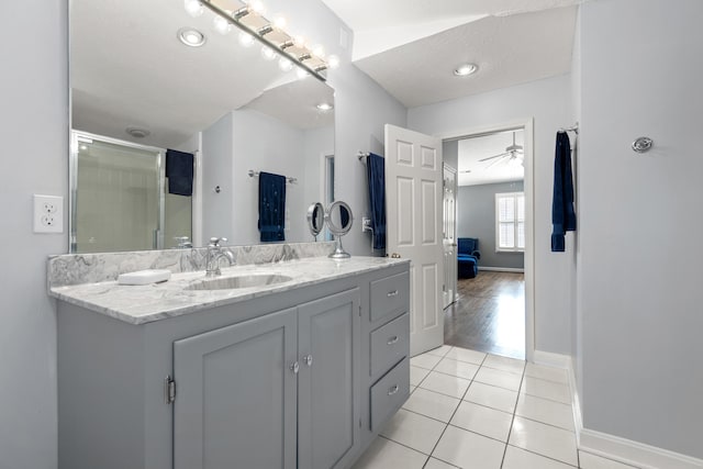 bathroom with tile patterned floors, a shower with shower door, vanity, a textured ceiling, and ceiling fan