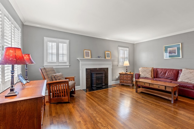 living room with crown molding, wood-type flooring, and a healthy amount of sunlight