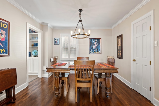 dining room with a notable chandelier, ornamental molding, and dark hardwood / wood-style flooring