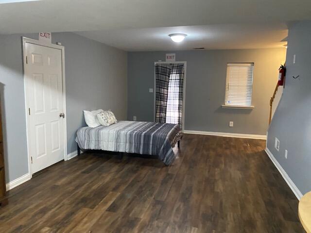 bedroom with dark hardwood / wood-style floors