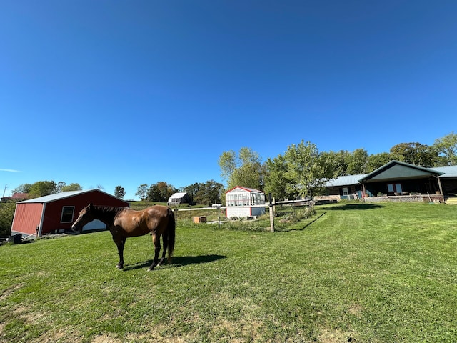 view of yard featuring an outbuilding and a rural view