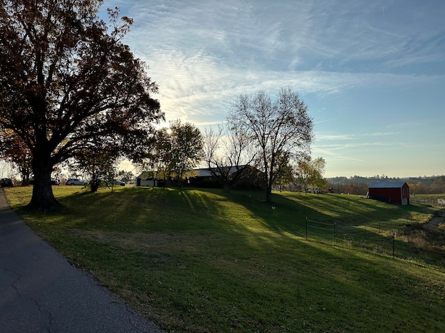 view of yard with a rural view and an outdoor structure