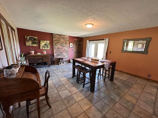 dining area featuring french doors and a textured ceiling