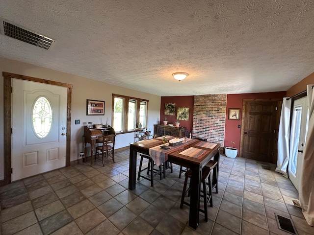 dining area featuring a textured ceiling