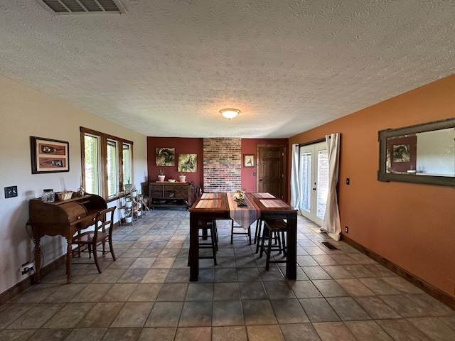 dining area featuring a textured ceiling