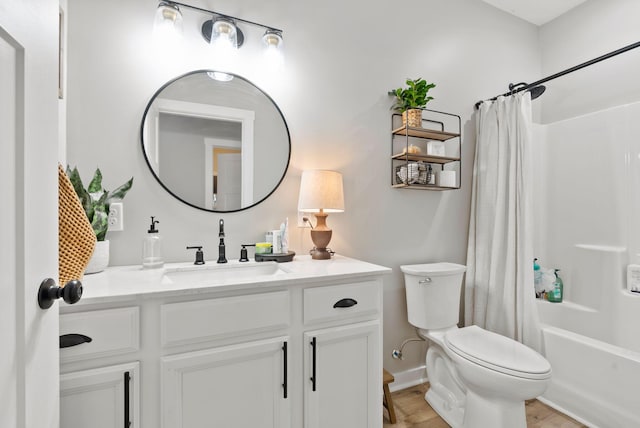 full bathroom featuring toilet, shower / bath combo with shower curtain, wood finished floors, and vanity