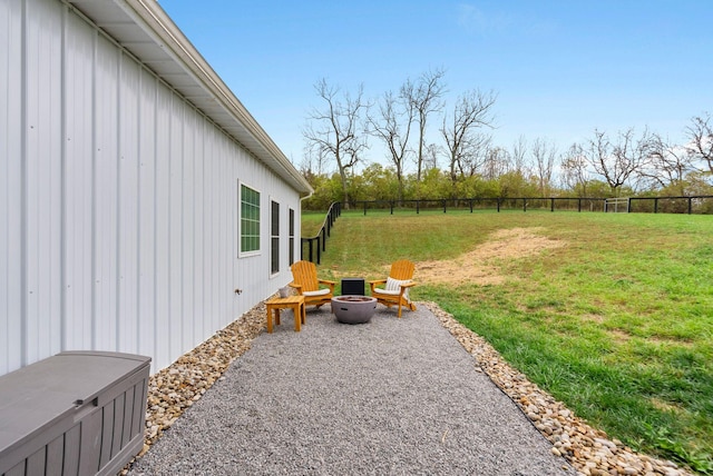 view of yard with an outdoor fire pit, fence, and a patio