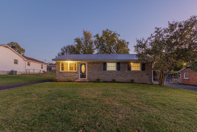 single story home with central AC and a lawn