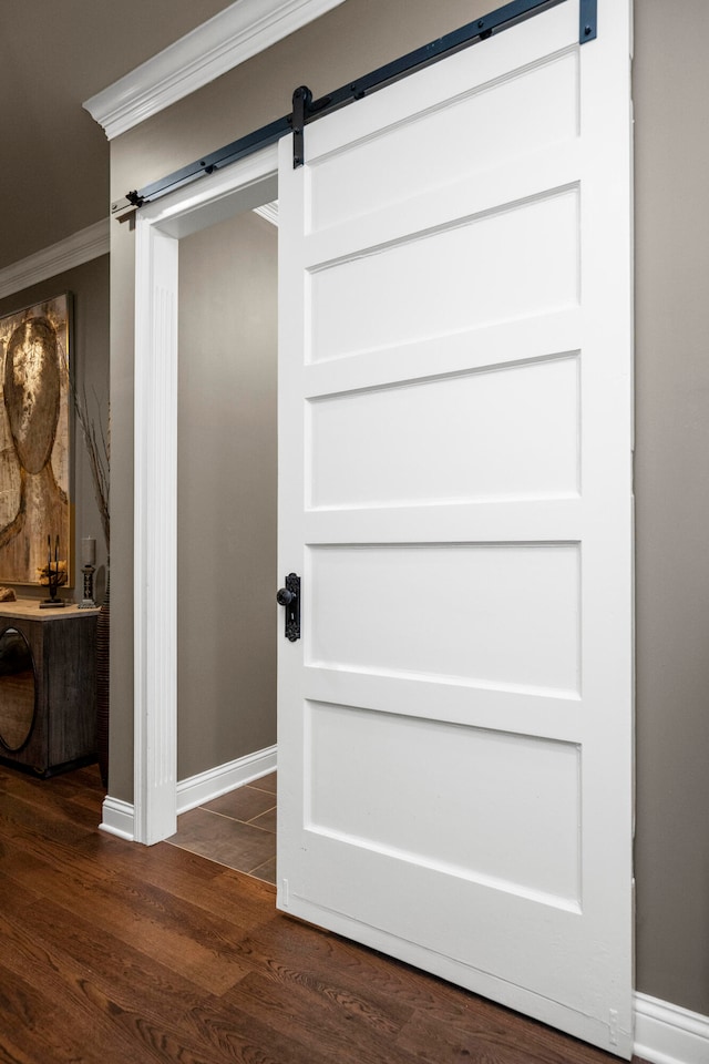 details with hardwood / wood-style floors, a barn door, and crown molding