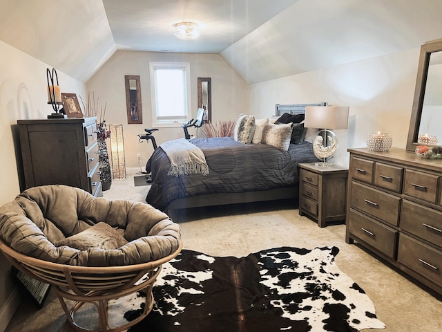 bedroom featuring light carpet and lofted ceiling