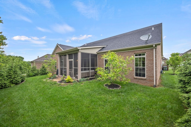 back of house featuring a yard and a sunroom