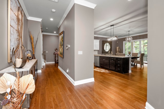 hall with crown molding and light wood-type flooring