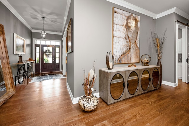 entryway featuring crown molding, hardwood / wood-style flooring, and a barn door