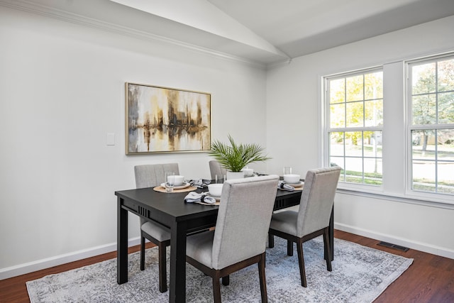 dining room featuring vaulted ceiling and dark hardwood / wood-style floors