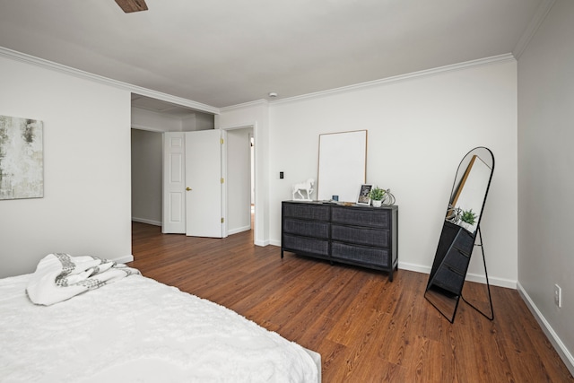 bedroom featuring crown molding and dark hardwood / wood-style floors