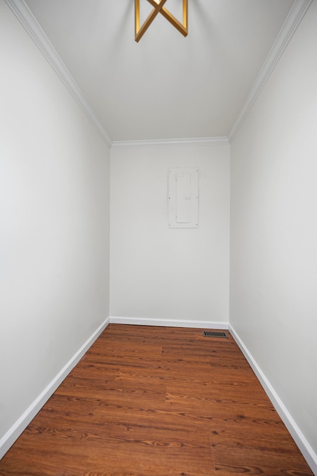 spare room featuring ornamental molding, hardwood / wood-style flooring, and electric panel