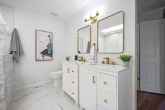 bathroom with vanity, ornamental molding, and toilet