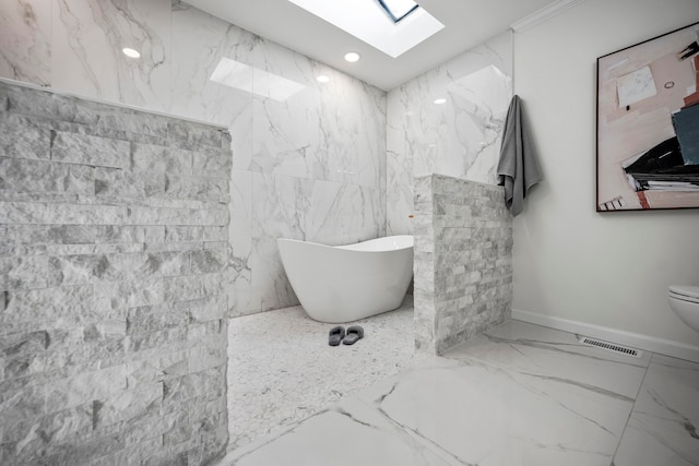 bathroom with a skylight, toilet, and a washtub