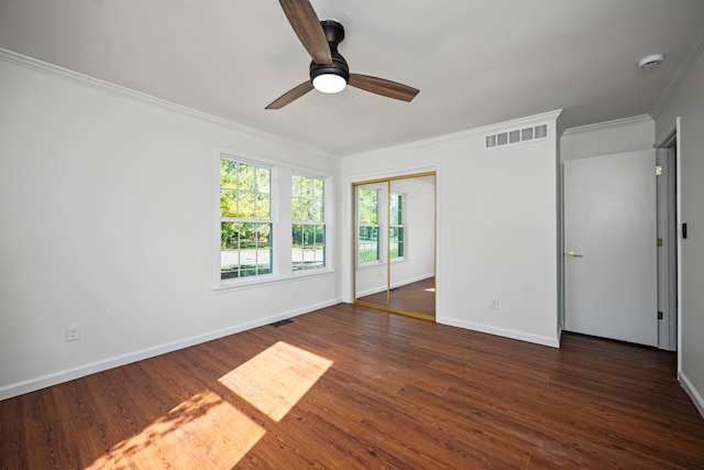 spare room featuring crown molding, dark hardwood / wood-style floors, and ceiling fan