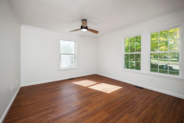 unfurnished room featuring dark wood-type flooring, ceiling fan, crown molding, and plenty of natural light