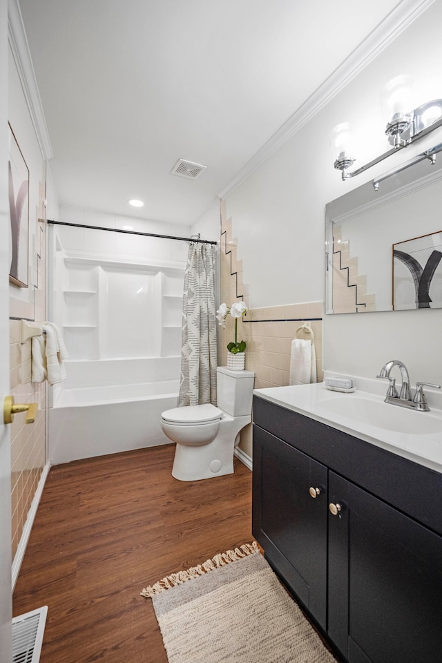 full bathroom with shower / bathtub combination with curtain, wood-type flooring, tile walls, toilet, and vanity