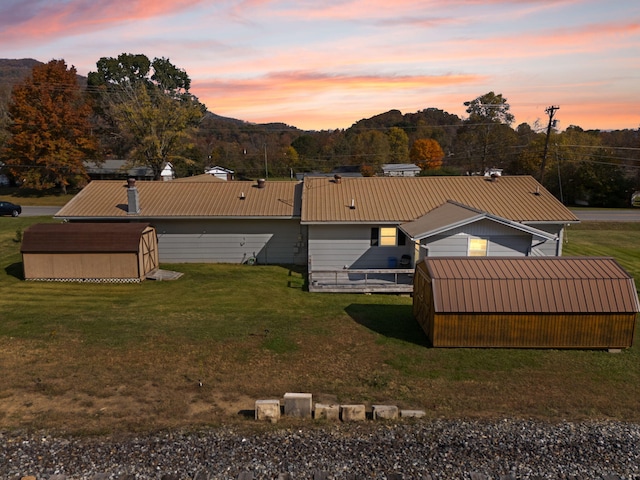 view of front of home with a yard and an outbuilding