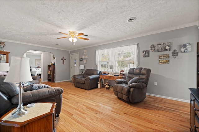 living room featuring light hardwood / wood-style floors, ornamental molding, a textured ceiling, and ceiling fan