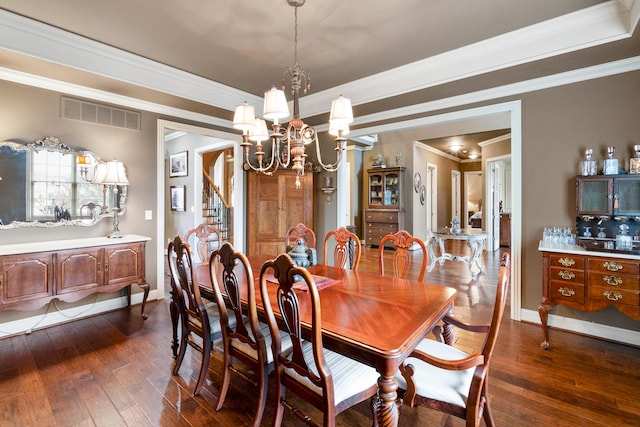 dining space featuring an inviting chandelier, dark hardwood / wood-style floors, and crown molding