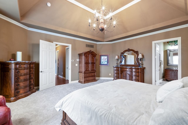 carpeted bedroom with ensuite bathroom, ornamental molding, a raised ceiling, and an inviting chandelier