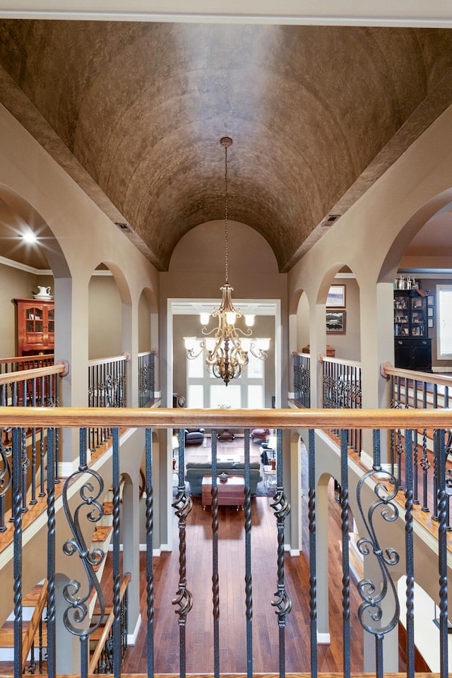 wine room featuring dark hardwood / wood-style flooring, lofted ceiling, and an inviting chandelier