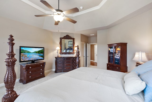 bedroom featuring a tray ceiling, light colored carpet, and ceiling fan