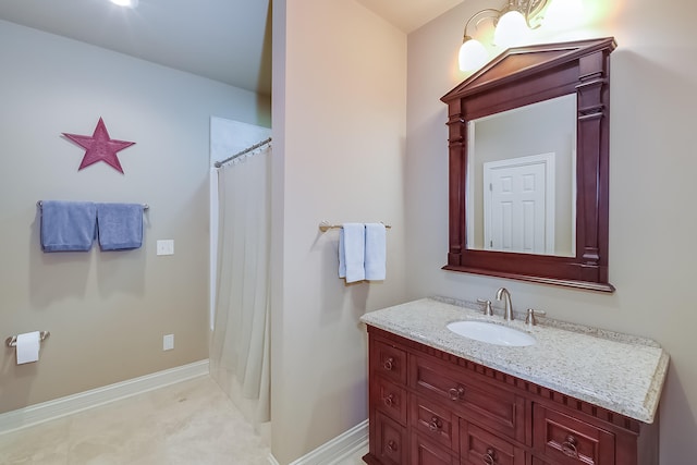 bathroom with walk in shower and vanity