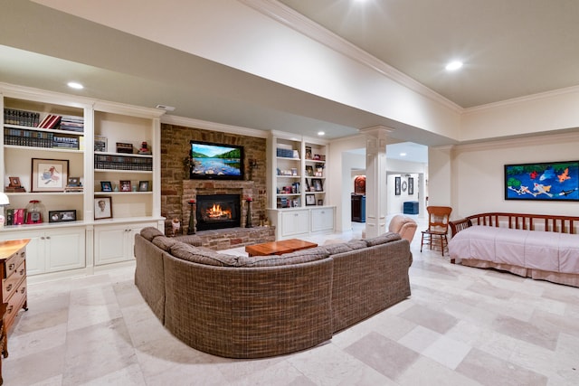 living room with built in shelves, a fireplace, ornamental molding, and ornate columns