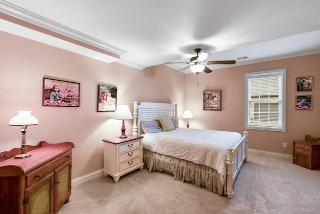 carpeted bedroom featuring ceiling fan and crown molding