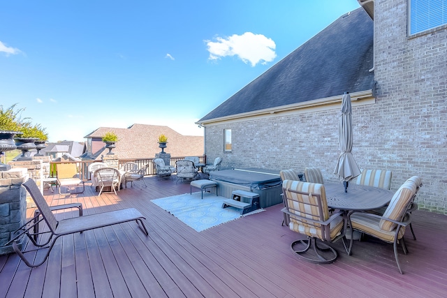 wooden deck featuring a hot tub