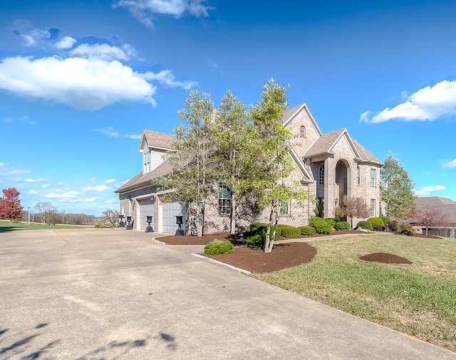 view of front of home with a garage and a front yard