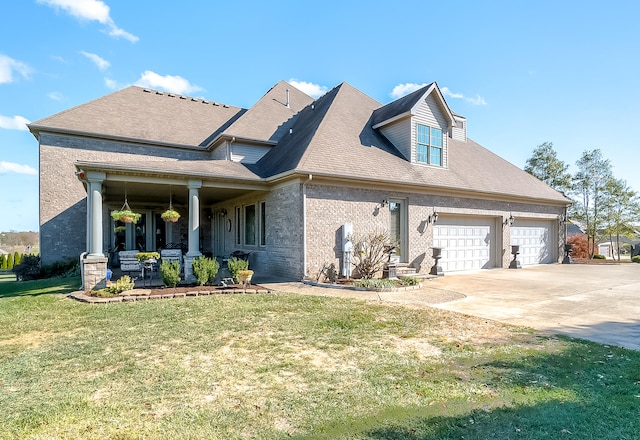 view of front facade featuring a front yard, covered porch, and a garage