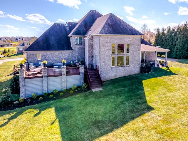 back of house with a deck and a lawn