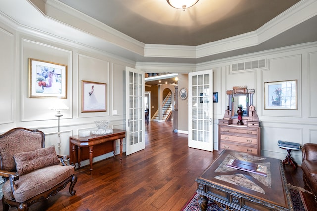 living area featuring ornamental molding, french doors, and dark hardwood / wood-style flooring