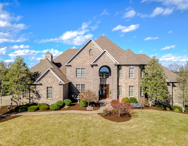 view of property featuring a front lawn