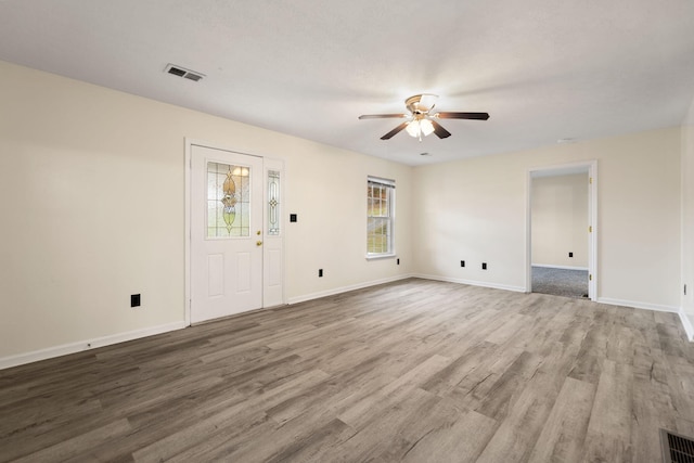 empty room featuring hardwood / wood-style flooring and ceiling fan